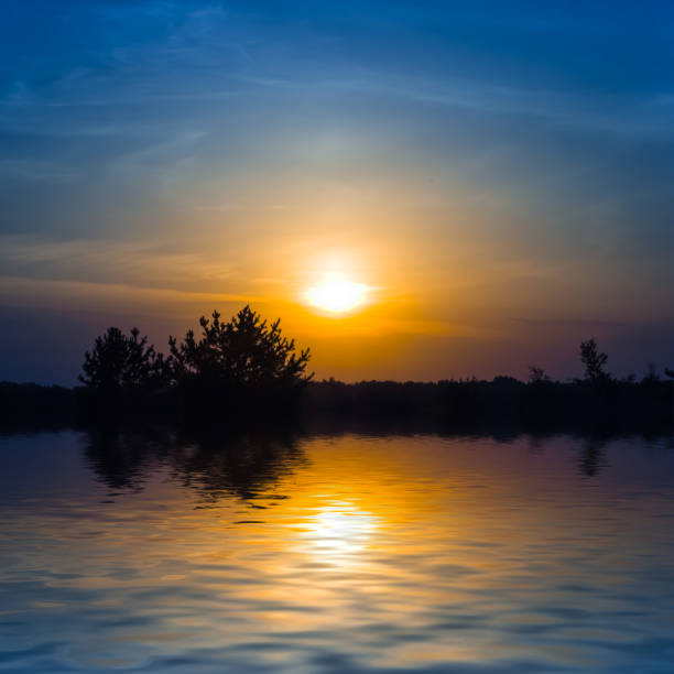 istock dramatic sunset over the small quiet lake, evening natural background 1422483173