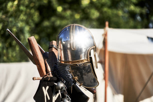 istock Bright shiny silver medieval knight helmet with reflections of sun rays 1422486512