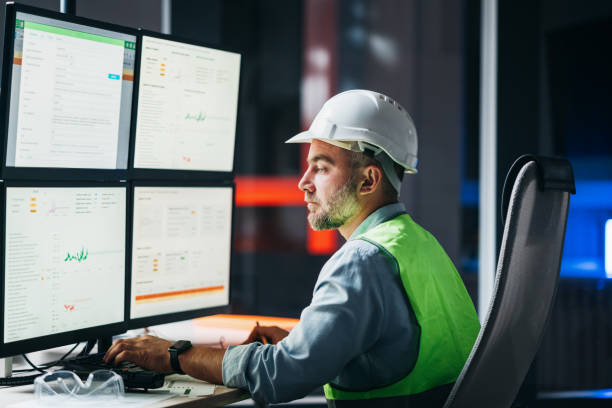 istock Bearded engineer follow of product line on modern factory. Operator control industry process using screens 1422487973