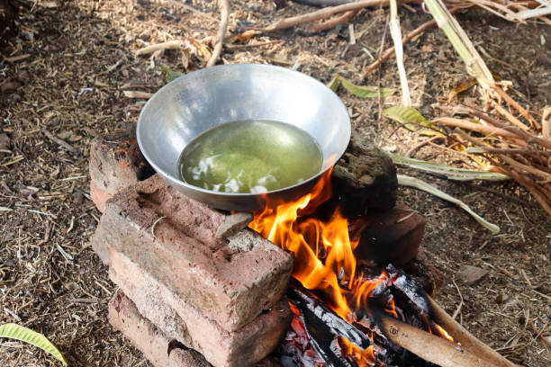 kadhai with oil placed on chulha made with bricks for cooking kadhai with oil placed on chulha for cooking outdoor by burning wood karahi stock pictures, royalty-free photos & images
