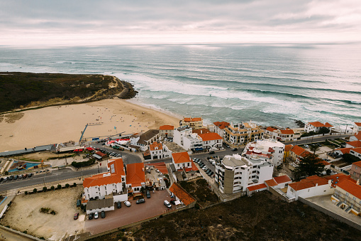Aerial Drone View of Portugal Coastal Town with Houses in Housing Market in Sintra, Lisbon, Europe, Cliff Top Properties and Homes on Coast with Sea View at Praia Das Macas Beach