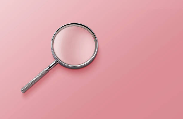 istock magnifying glass on pink background top view lying flat copy space concept 1422496392