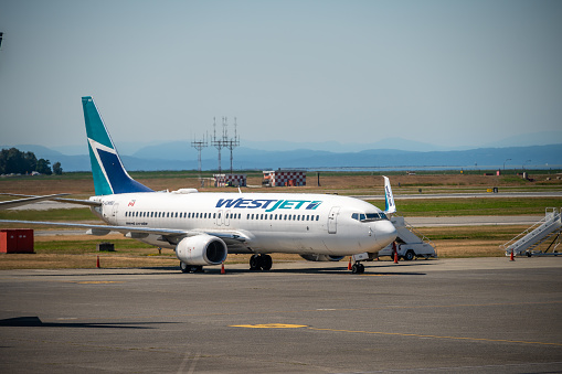 Vancouver, British Columbia - July 31, 2022: Westjet aircraft on the tarmac of Vancouver's international airport.