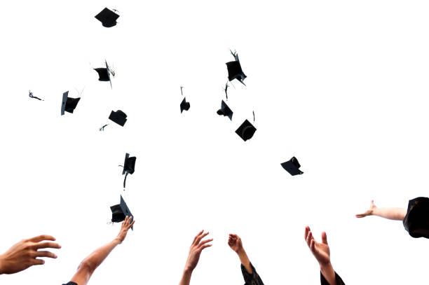 istock Graduating students hands throwing graduation caps on white background 1422515975