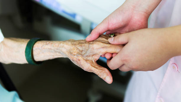 istock Young hands touch and hold an old woman's wrinkled hands 1422516109