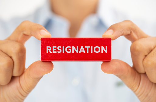 Business person showing resignation word.