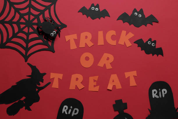 istock Halloween holiday. Composition with various halloween paper figures. view from above. on red background 1422517877