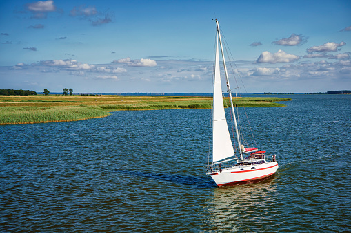 Sailing boat on the Zingster Strom river, Fischland-Darß Peninsula, Mecklenburg-West Pomerania, Germany