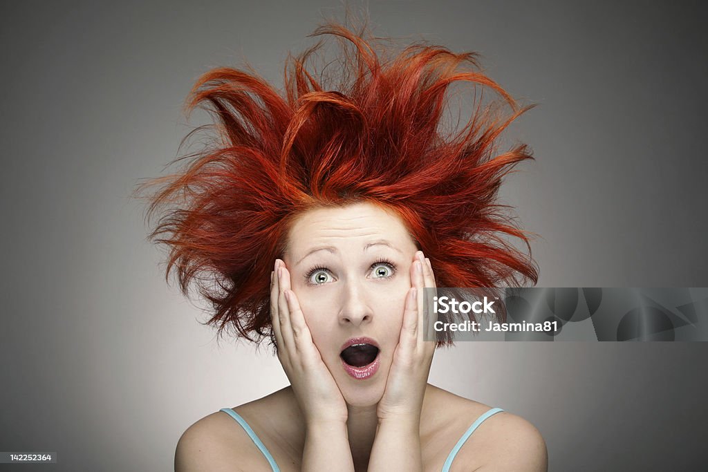 Bad hair day Redhead woman with messy hair against gray background Tangled Hair Stock Photo