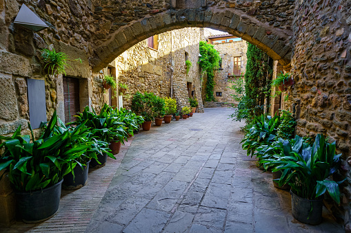 Passageways with stone arcade and medieval houses in a picturesque style and of great beauty, Monells, Girona, Catalonia