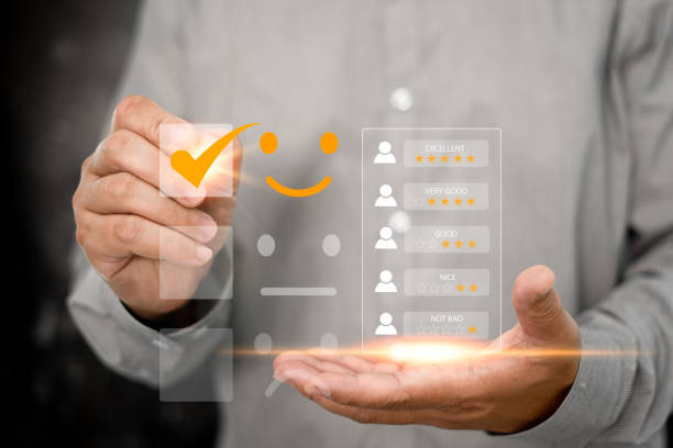 istock User gives rating to service experience on online application, Customer review satisfaction feedback survey concept,Business people point virtual screen on the happy Smiley face icon satisfaction 1422524277