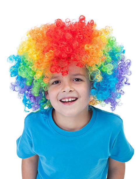 Happy clown boy - isolated portrait Happy clown boy with large colorful wig - isolated wig stock pictures, royalty-free photos & images
