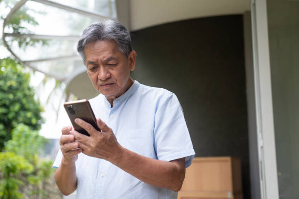 istock Asian elder man looking at smartphone and feeling stressful 1422527223