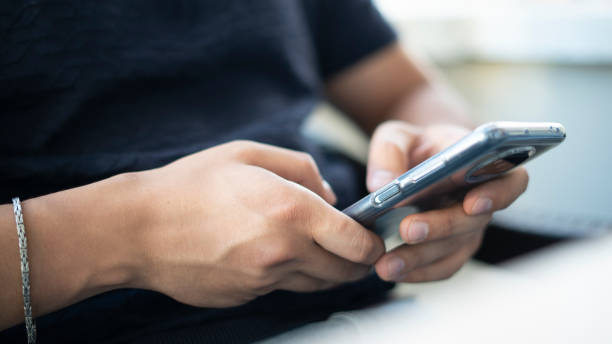 istock Young man holding the phone 1422527507