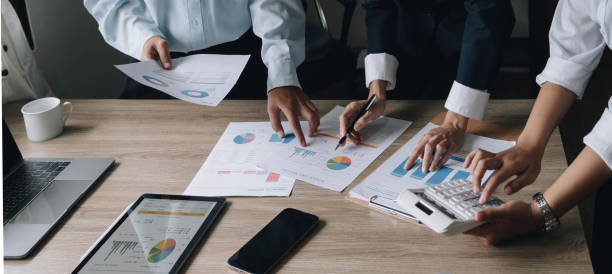 istock Closeup hands of Business team colleagues working and discussing with various document graph and statistic together in meeting room when brainstorming project management, strategy for success concept 1422531128