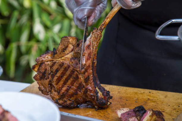 istock Chef carving tomahawk steak on wooden table 1422532288