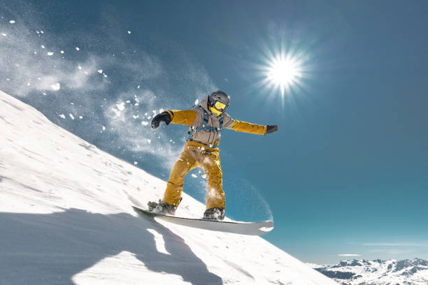 istock Real snowboarder jumps at ski slope 1422542189