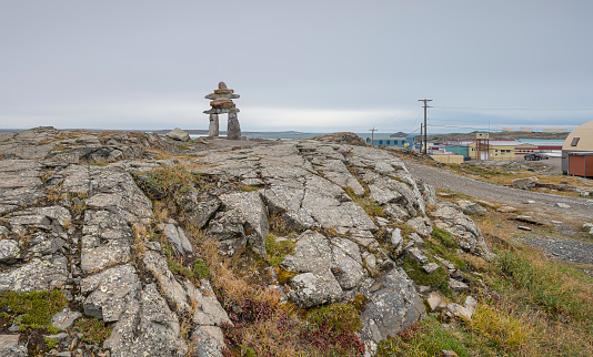Inukshuk (Inuksuk) on hilltop at the entrance to Rankin Inlet on the Hudson Bay