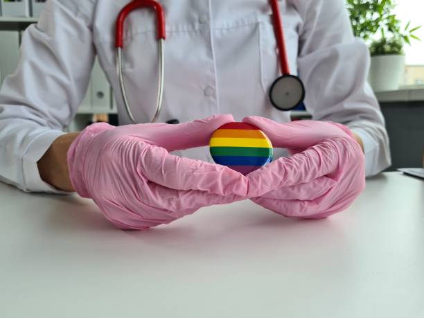 health care lgbt and doctor holding lgbt badge - men sensuality photography high angle view imagens e fotografias de stock