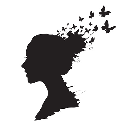 Beautiful girl's profile silhouette with butterflies flying from her hair