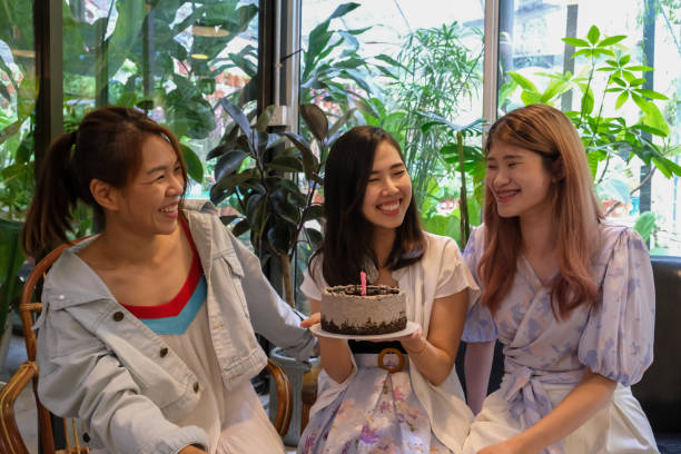 istock A young lady hold the birthday cake and smile 1422551344