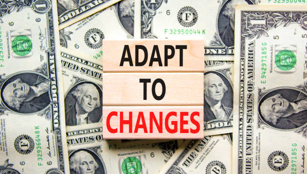 istock Adapt to changes symbol. Concept words Adapt to changes on wooden blocks on dollar bills. Beautiful background from dollar bills. Business and Adapt to changes quote concept. Copy space. 1422554104