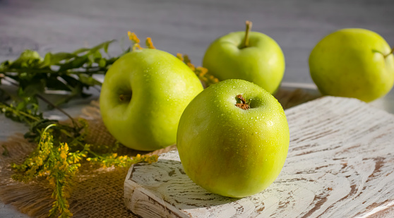Fresh apples on old background