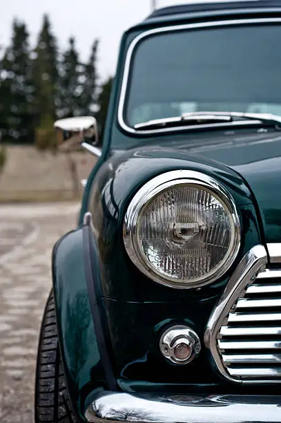 Particular of vintage classic english car in green color front View
