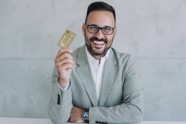 istock Man holding a credit card. 1422565502