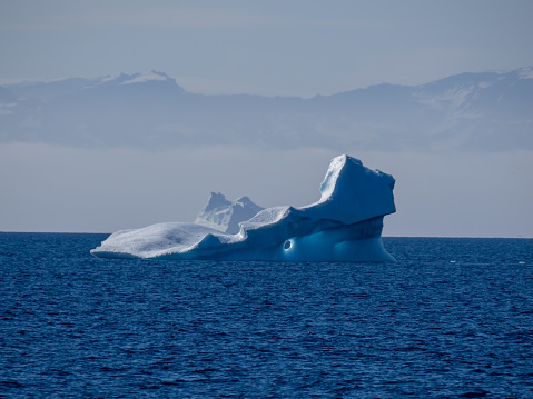 Enormous icebergs with sculptural forms of great beauty crowding the waters of the Disko Bay north of the Artic Circle near Ilulissat, Western Greenland