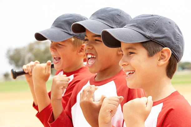 Young Boys In Baseball Team Young Boys In Baseball Team Cheering only boys stock pictures, royalty-free photos & images