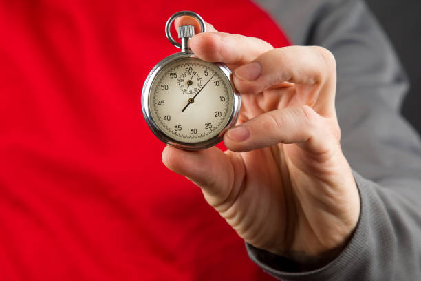 istock mechanical stopwatch in hand. Time part precision. Measuring the speed interval with a watch 1422568462
