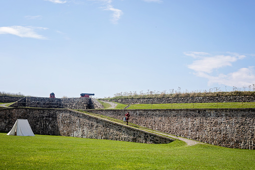 Louisbourg, Canada - August 27, 2022. People explore the historic buildings at the Fortress of Louisbourg.