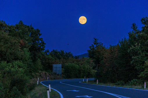 Full moon and winding road in Slovenia