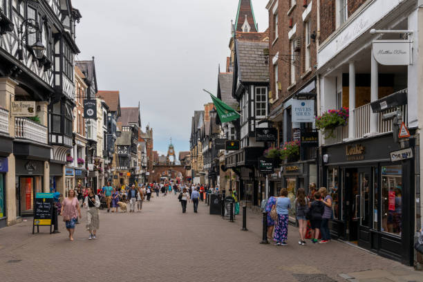 view of the historic city center of Chester with many people out and about in the busy High Street Chester, United Kingdom - 26 August, 2022: view of the historic city center of Chester with many people out and about in the busy High Street chester england stock pictures, royalty-free photos & images