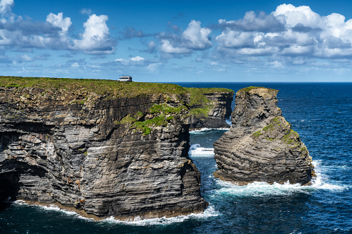 A camper van parked close to the edge at the Kilkee Cliffs in County Clare on the Wild Atlantic Way scenic drive