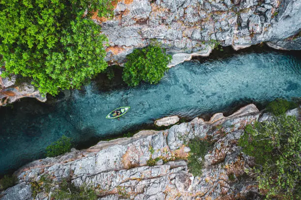 Photo of Aerial view of Kayak on river flowing in canyon