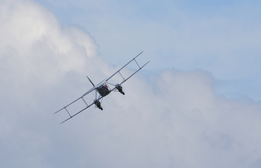 Glider Being Towed By Small Airplane. The sky is dramatic and very cloudy, in preparation for a storm.