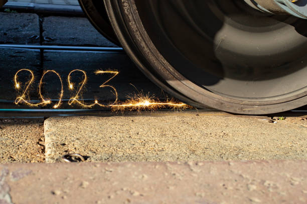 Number 2023 written with sparkling sparklers on railway tracks