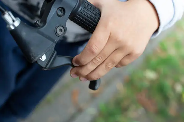 Photo of Child's hand holding the brakes on a bicycle