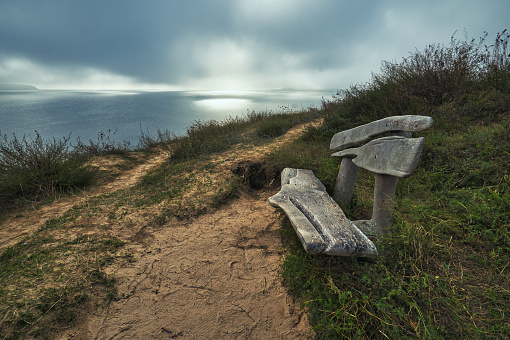 An empty bench looking out to the beautiful coastline of Northumberland and the North Sea