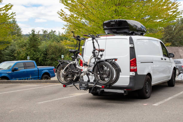 Two E-Bikes on Bicycle Rack on Back of Van 