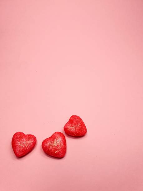 istock small red hearts on a soft pink colored background, copy space. Valentine's Day concept for design 1422590224