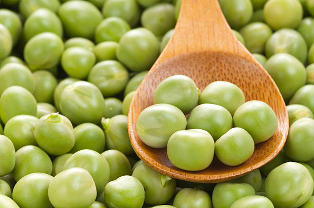 istock Fresh grren peas on wooden spoon 142259956