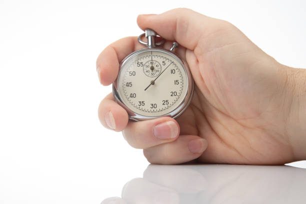 istock hand with a mechanical stopwatch on a white background. 1422600024