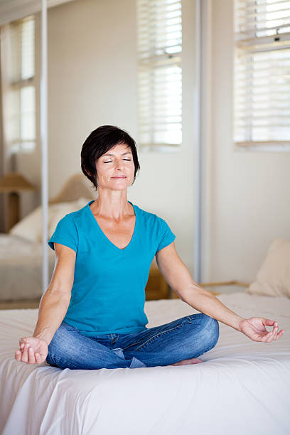 istock middle aged woman doing yoga meditation 142260049