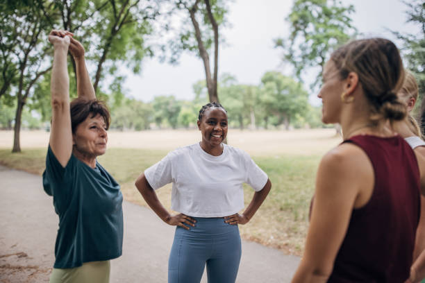 istock Women exercising together in park 1422605568