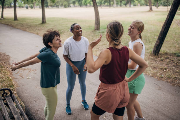 istock Women exercising together in park 1422605592