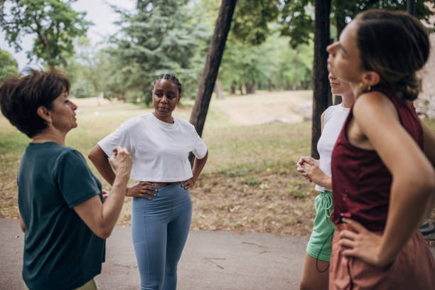 istock Women exercising together in park 1422605729
