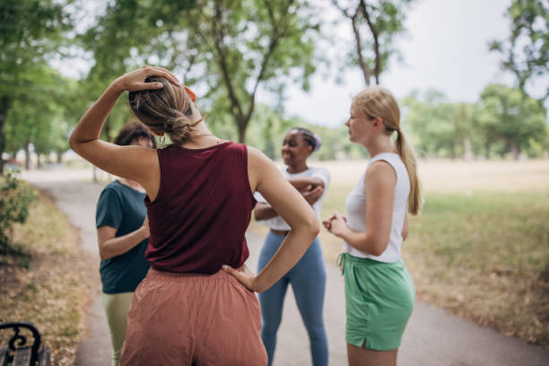 istock Women exercising together in park 1422605760